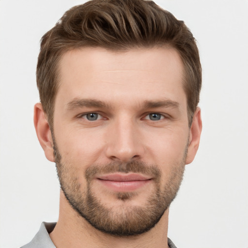 Joyful white young-adult male with short  brown hair and grey eyes