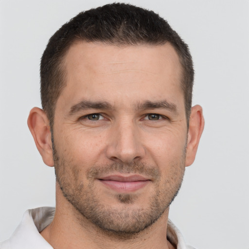 Joyful white young-adult male with short  brown hair and brown eyes