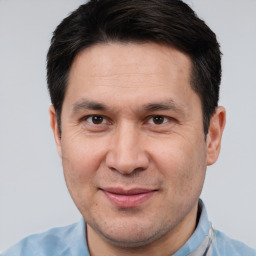 Joyful white adult male with short  brown hair and brown eyes