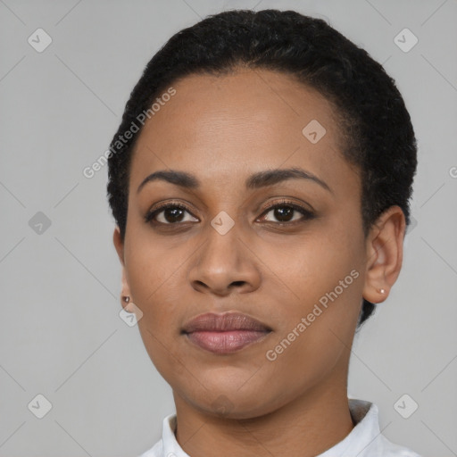 Joyful black young-adult female with short  black hair and brown eyes