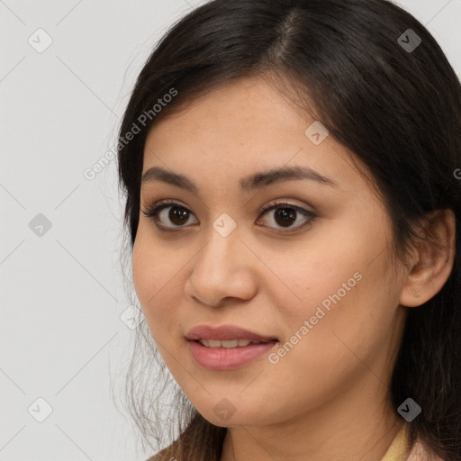 Joyful latino young-adult female with long  brown hair and brown eyes