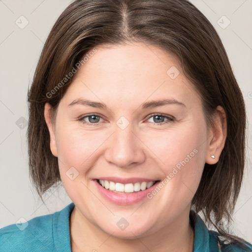 Joyful white young-adult female with medium  brown hair and grey eyes