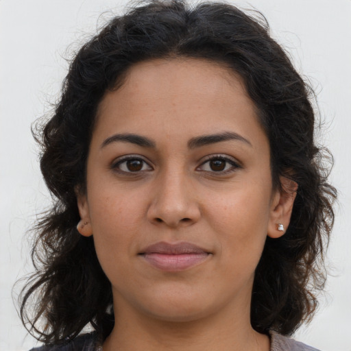 Joyful latino young-adult female with long  brown hair and brown eyes