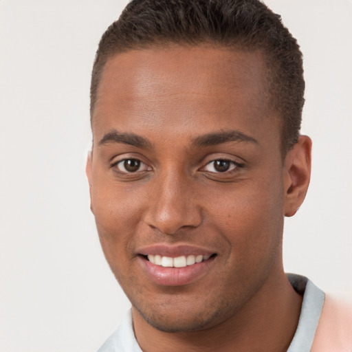 Joyful black young-adult male with short  brown hair and brown eyes