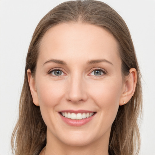 Joyful white young-adult female with long  brown hair and grey eyes