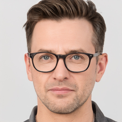 Joyful white adult male with short  brown hair and grey eyes