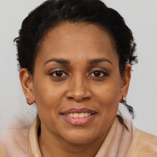 Joyful black adult female with short  brown hair and brown eyes
