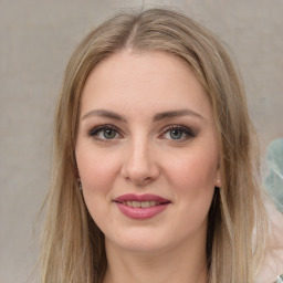 Joyful white young-adult female with long  brown hair and green eyes