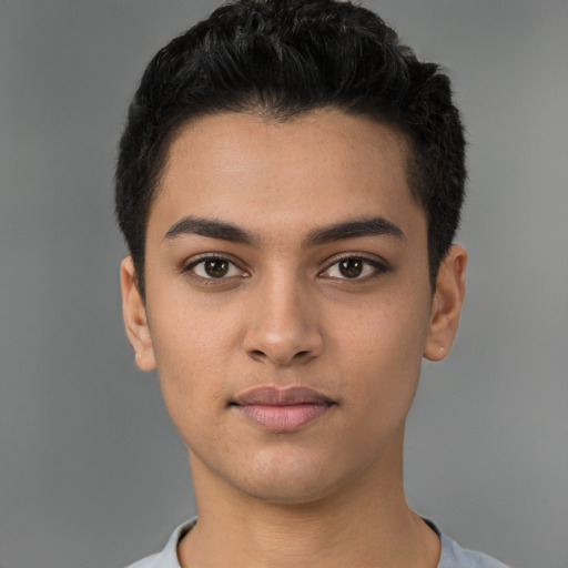 Joyful latino young-adult male with short  black hair and brown eyes