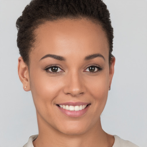 Joyful white young-adult female with short  brown hair and brown eyes