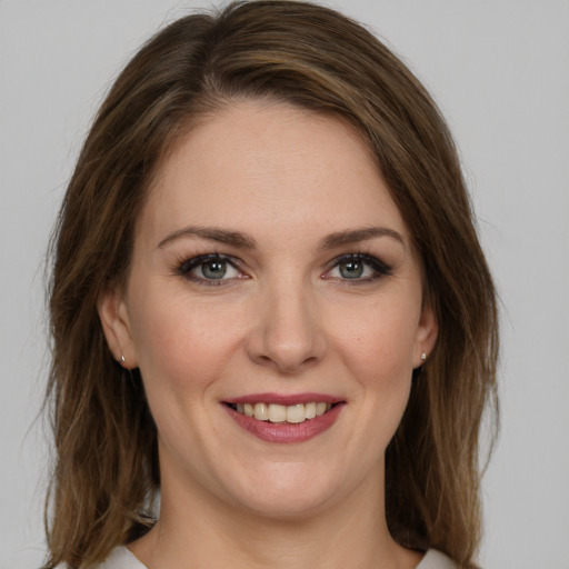 Joyful white young-adult female with medium  brown hair and green eyes