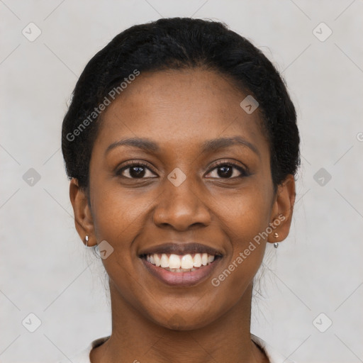 Joyful black young-adult female with short  black hair and brown eyes