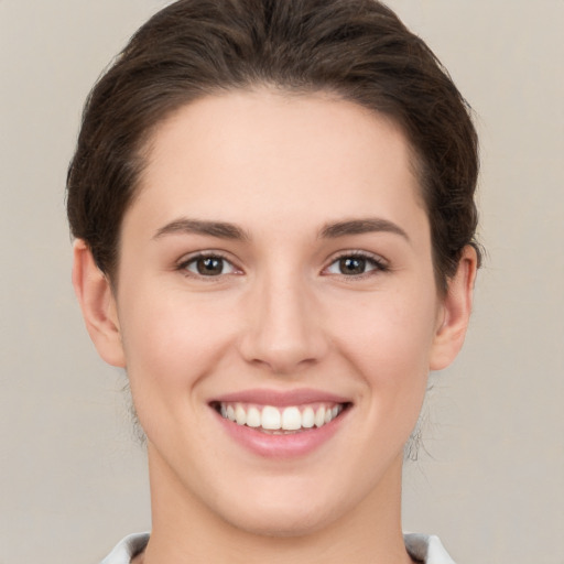 Joyful white young-adult female with short  brown hair and brown eyes