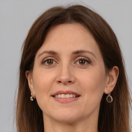 Joyful white adult female with long  brown hair and grey eyes