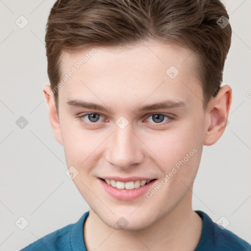 Joyful white young-adult male with short  brown hair and grey eyes