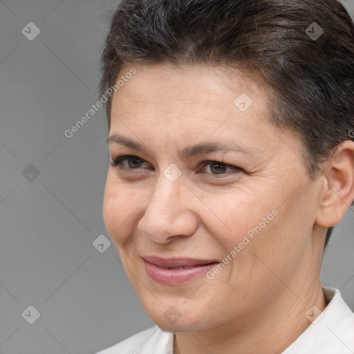 Joyful white adult female with short  brown hair and brown eyes