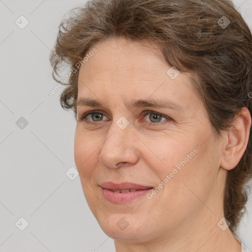 Joyful white adult female with medium  brown hair and brown eyes