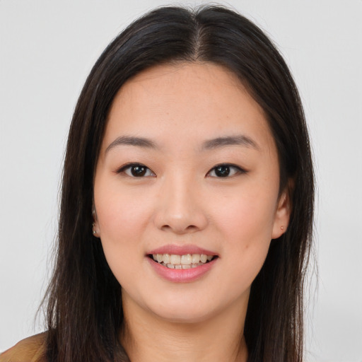 Joyful asian young-adult female with long  brown hair and brown eyes