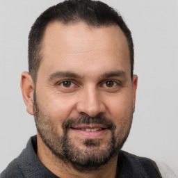 Joyful white adult male with short  brown hair and brown eyes