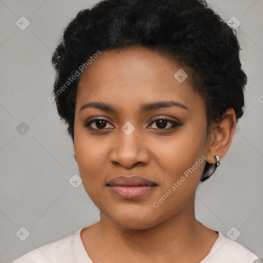 Joyful black young-adult female with short  black hair and brown eyes