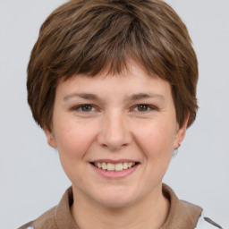 Joyful white young-adult female with short  brown hair and grey eyes