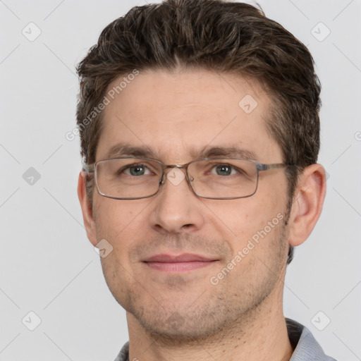 Joyful white adult male with short  brown hair and grey eyes