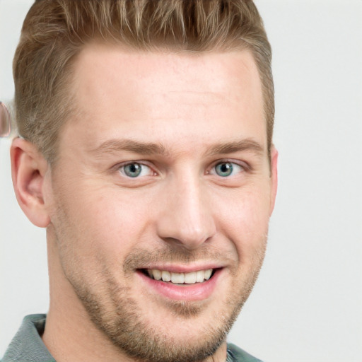 Joyful white adult male with short  brown hair and blue eyes