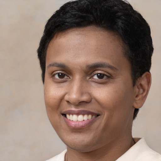 Joyful latino young-adult male with short  brown hair and brown eyes