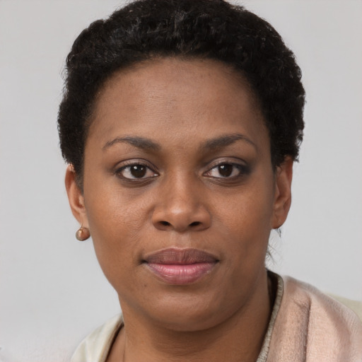 Joyful black young-adult female with short  brown hair and brown eyes