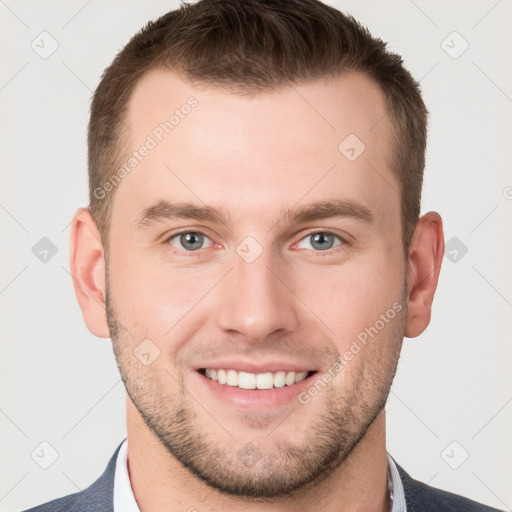 Joyful white young-adult male with short  brown hair and grey eyes