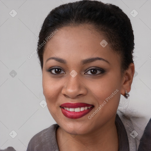 Joyful black young-adult female with short  brown hair and brown eyes