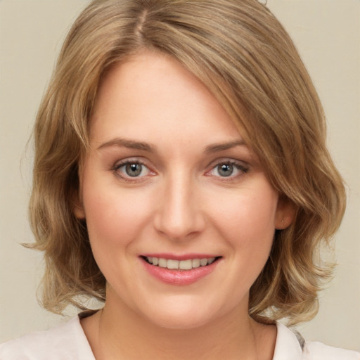 Joyful white young-adult female with medium  brown hair and green eyes