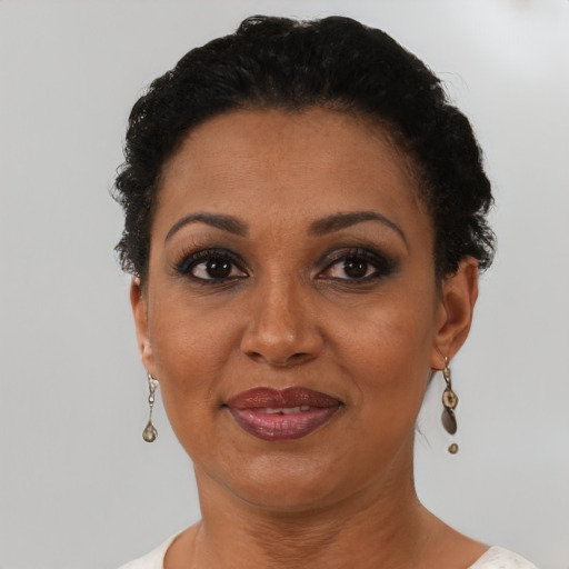 Joyful black adult female with short  brown hair and brown eyes