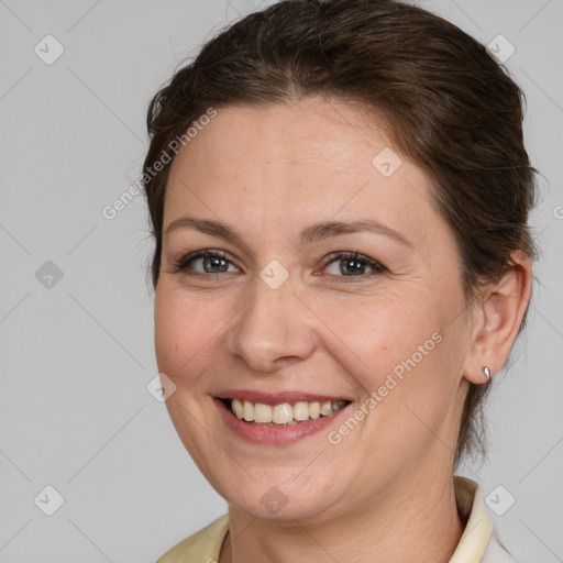 Joyful white adult female with medium  brown hair and brown eyes