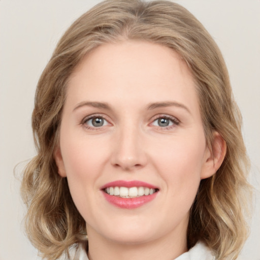 Joyful white young-adult female with medium  brown hair and green eyes