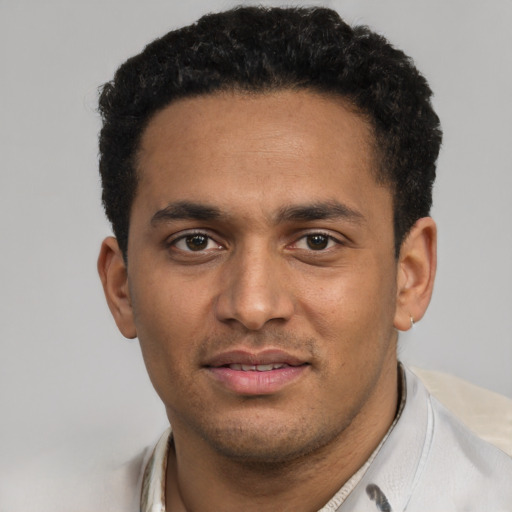 Joyful black young-adult male with short  black hair and brown eyes