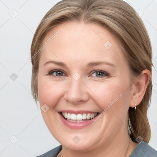 Joyful white young-adult female with medium  brown hair and blue eyes