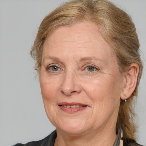 Joyful white middle-aged female with medium  brown hair and brown eyes