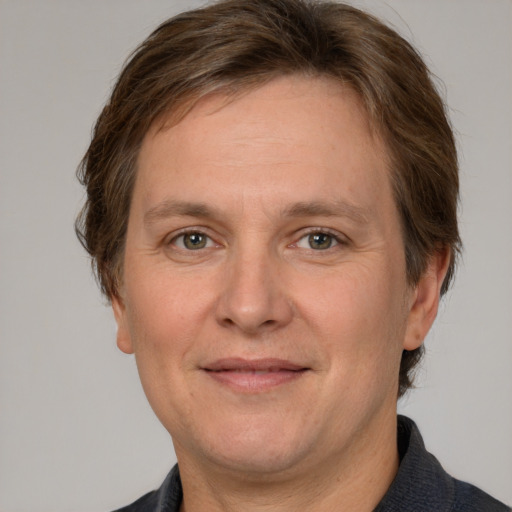 Joyful white adult male with short  brown hair and grey eyes