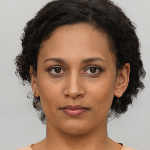 Neutral latino adult female with short  brown hair and brown eyes