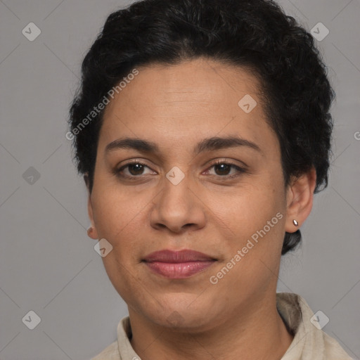 Joyful latino adult female with short  brown hair and brown eyes