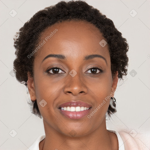 Joyful black young-adult female with short  brown hair and brown eyes