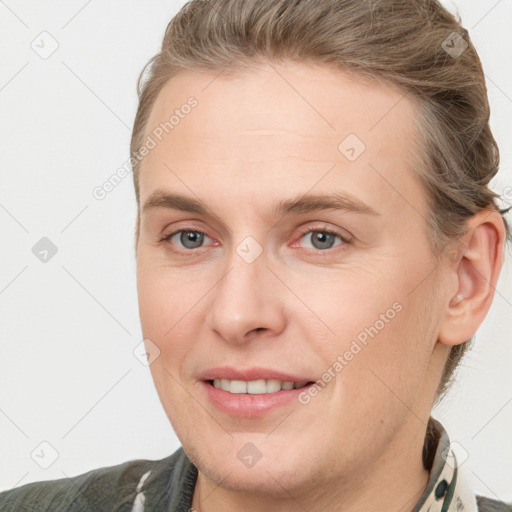 Joyful white adult female with short  brown hair and grey eyes