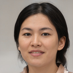 Joyful asian young-adult female with medium  black hair and brown eyes