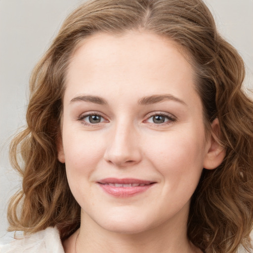 Joyful white young-adult female with medium  brown hair and blue eyes