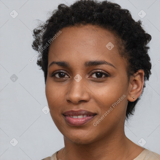 Joyful black young-adult female with short  brown hair and brown eyes