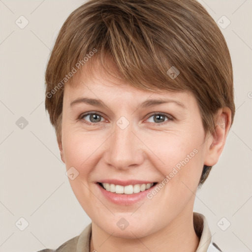 Joyful white young-adult female with short  brown hair and grey eyes