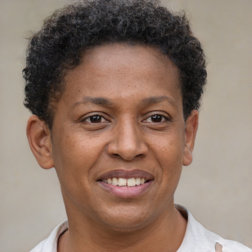 Joyful latino adult female with short  brown hair and brown eyes