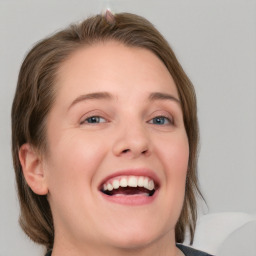 Joyful white young-adult female with medium  brown hair and blue eyes