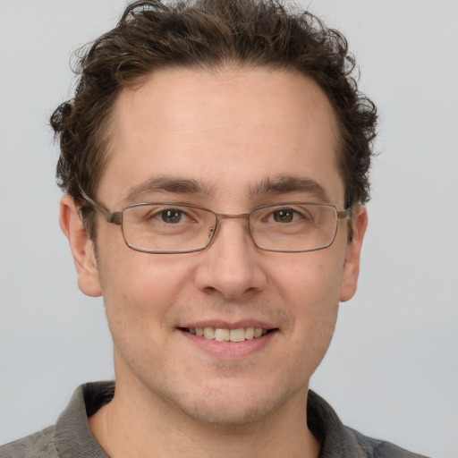 Joyful white adult male with short  brown hair and grey eyes